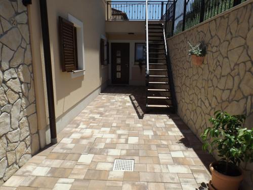 a hallway of a house with a stone wall and stairs at Apartments Villa Elma in Mošćenička Draga
