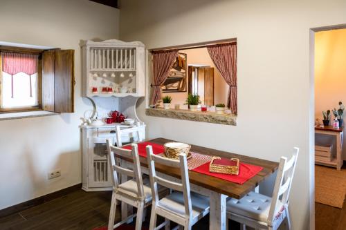 a dining room with a table and chairs and a mirror at Quinta Ze do Coval in Arouca