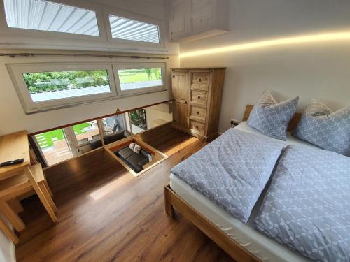 a bedroom with a bed and two windows at Ferienhaus am See-2 in Hungen