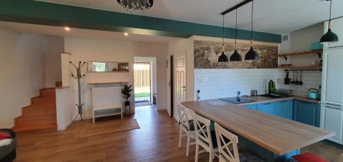 a kitchen with blue cabinets and a wooden table at Dom w mieście Reszel in Reszel