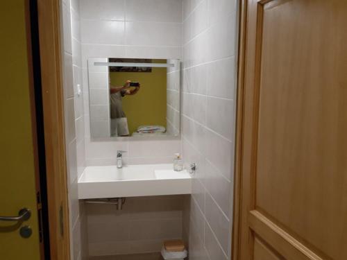 a person taking a picture of a bathroom sink at GITE AUBERGE EDELWEISS in Seyssel