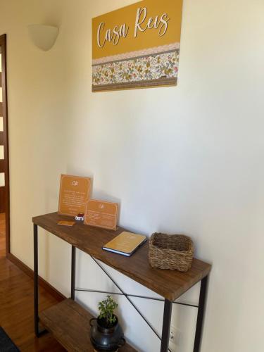 a wooden table with two signs on a wall at Herdade do Gizo - Casa Reis in Cuba