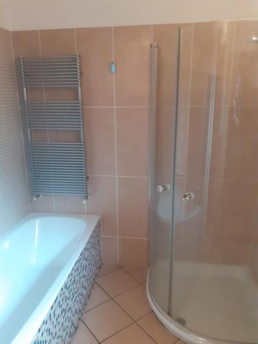 a bathroom with a shower and a tub at La Corte Dei Cappuccini in Bergamo