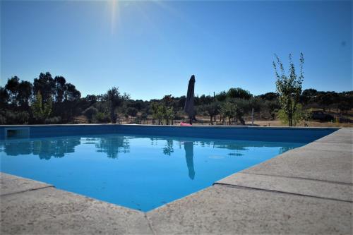 a swimming pool with blue water at Monte da Fonte Santa de São Luís in Castelo Branco