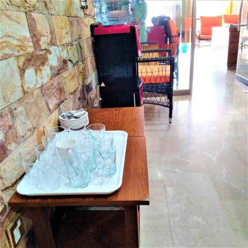 a tray of glasses and plates on a table at Hotel Vista Inn DHA in Rawalpindi
