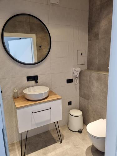 a bathroom with a sink and a mirror at Apartamenty ApartPark - visitopl in Świnoujście