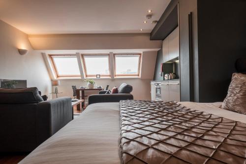 a bedroom with a bed and a living room at The Chambers in Leeds
