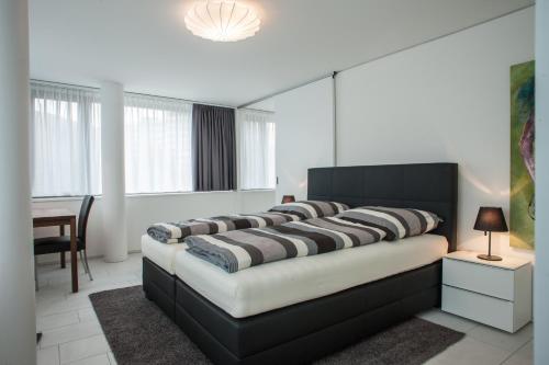 1 dormitorio con 1 cama grande en una habitación en CITY STAY - Zugerstrasse, en Cham