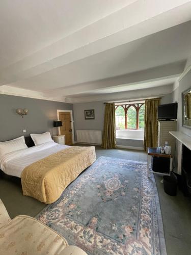 a bedroom with two beds and a large rug at Abbey Farm Bed And Breakfast in Atherstone