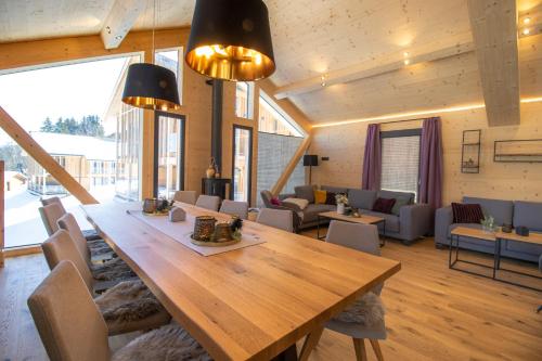 a large dining room with a large wooden table at Bergresort Hauser Kaibling by ALPS RESORTS in Haus im Ennstal
