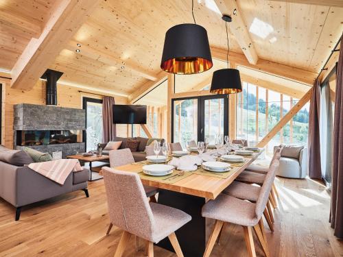 a dining room with a table and chairs at Bergresort Hauser Kaibling by ALPS RESORTS in Haus im Ennstal