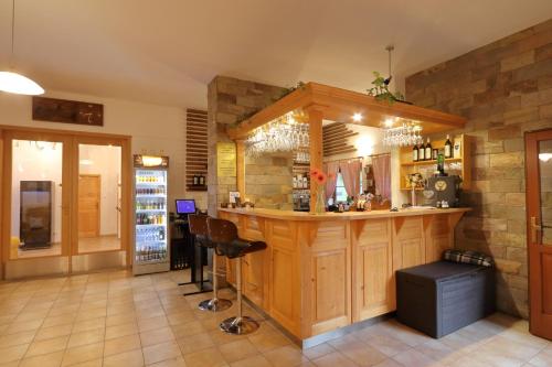 a bar in a restaurant with a counter in a room at Penzión Solisko*** Oščadnica in Oščadnica