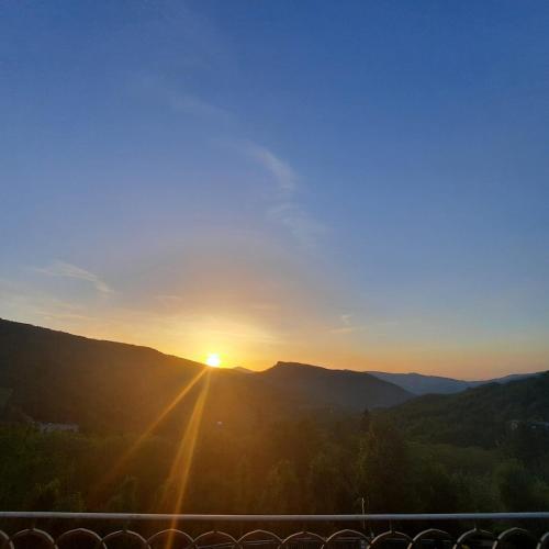 a view of the sun setting over the mountains at Hotel Bellavista in Abetone