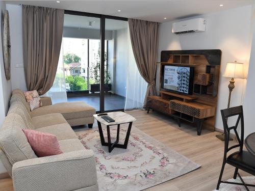 a living room with a couch and a tv at BAZ TOWER in Nicosia