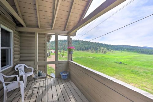 a porch of a house with a chair and a window at On-Site Hiking Access Mtn-View Conifer Cabin in Conifer
