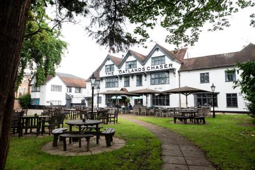 a group of tables and chairs in front of a building at The Oatlands Chaser by Innkeeper's Collection in Weybridge