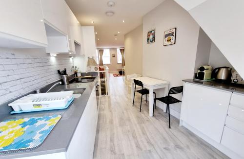 a kitchen with a sink and a counter top at Modern Maisonette 2 Bedrooms Newly Renovated in Bournemouth