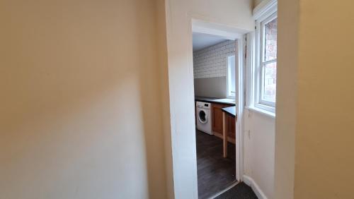 a small kitchen with a sink and a window at Grace Apartments - Living Rock in Ashford