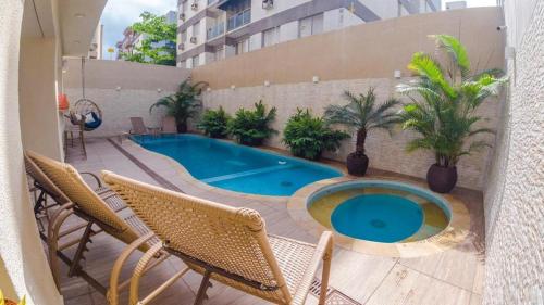a swimming pool on the side of a building at Pousada Ilha das Conchas in Guarujá