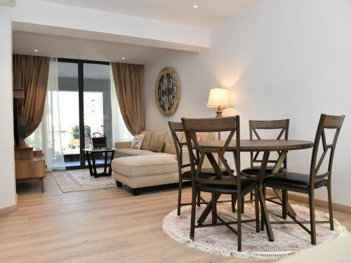 a living room with a table and chairs and a couch at BAZ TOWER in Nicosia