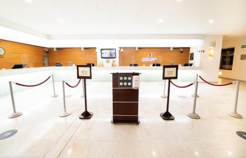 a lobby with a waiting area with signs on the floor at Emporio Acapulco in Acapulco