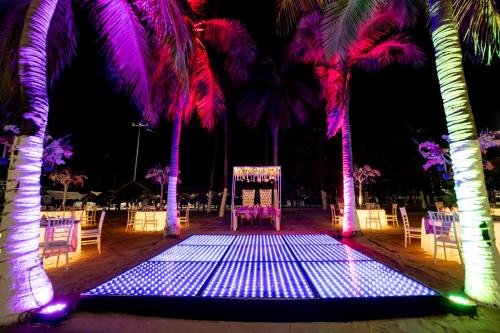 a wedding set up with palm trees and a chair at Emporio Acapulco in Acapulco