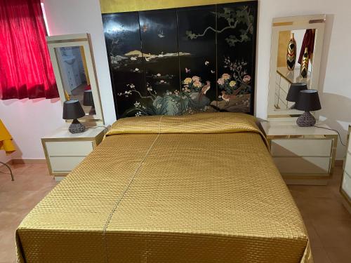 a bedroom with a bed with a yellow bedspread at Centro estivo Il Piccolo Paradiso in Sonnino