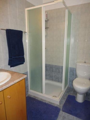 a bathroom with a shower and a toilet and a sink at Apartments Mackenzie 1+1 in Larnaka