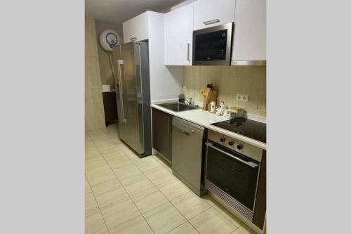 a kitchen with a sink and a stove at Apartamento com Vista para a Baía de Luanda in Luanda