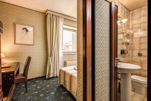 a hotel room with a bathroom with a bed and a sink at Venice Michelangelo Hotel in Mestre