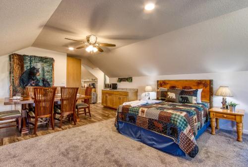 a bedroom with a bed and a dining room at Baby Bear by HoneyBearCabins in Sevierville