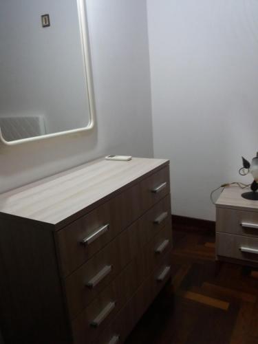 a bathroom with a sink and a mirror on a dresser at Lampedusa Vi attende in Lampedusa