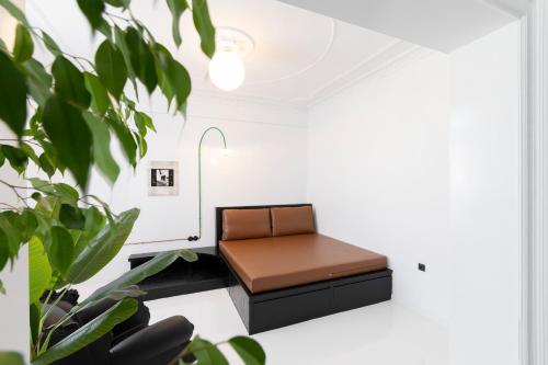 a brown leather chair in a room with plants at Trilogy Black in Thessaloniki