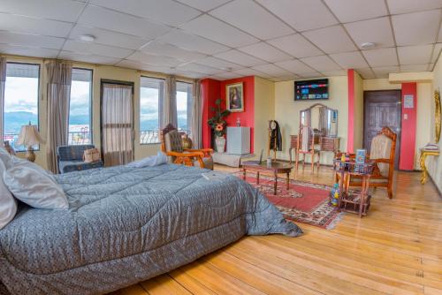 a bedroom with a bed and a living room at Hotel Royalty in Riobamba