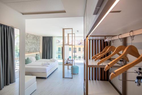 a room with a bed and a living room at THE ONE CAORLE - Hotel & Apartments in Caorle
