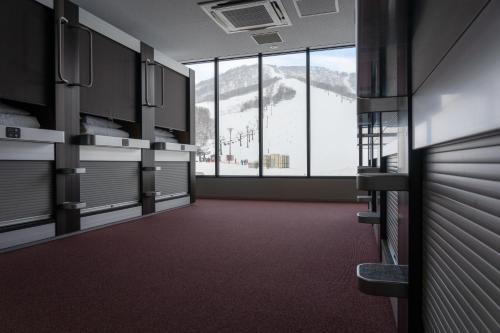 an empty room with a view of a ski resort at The Lodge Moiwa 834 in Niseko