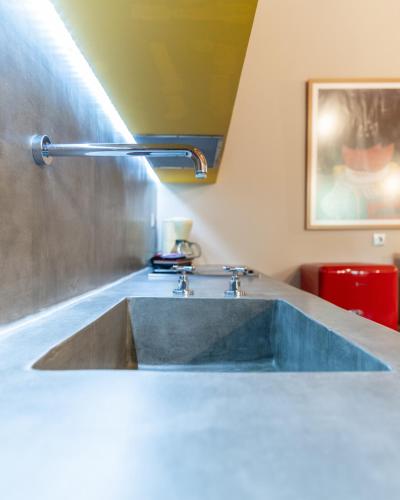 a bathroom with a sink with a faucet at Boutique Stone Cottage in Dhímaina