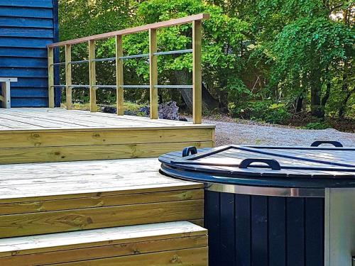 a wooden deck with a trash can sitting on it at 12 person holiday home in Glesborg in Glesborg