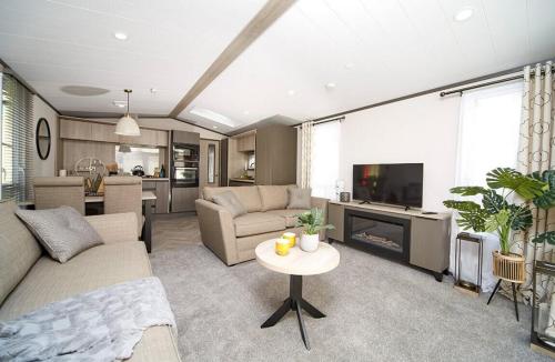a living room with a couch and a tv and a table at 1.2 padstow in Padstow