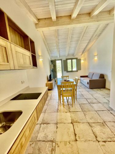 a kitchen and living room with a table and chairs at Tenuta Paltusa in Calangianus