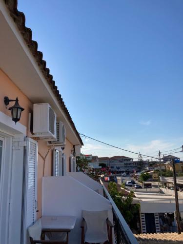 a balcony with a table and chairs on a building at Two Brothers Studios Tsilivi Zakynthos in Tsilivi