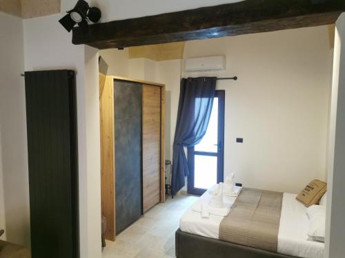 a bedroom with a bed and a window in a room at Loft Porta Sud in Brindisi