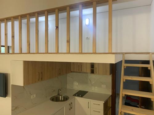 a loft bed with a sink in a kitchen at Pogradec Lake Apartments in Pogradec
