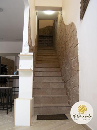 a staircase in a building with a stone wall at IL GIRASOLE in Porto Torres