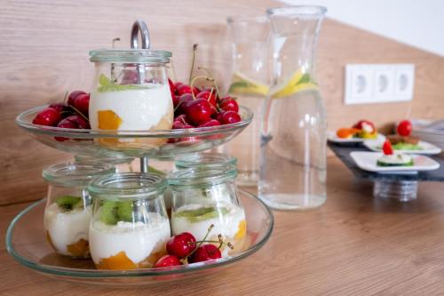 a table with two bowls of fruit in jars at Amaro Hotel in Bergkirchen