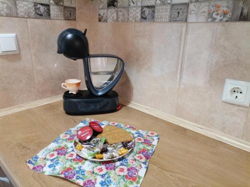 a table with a plate of food and a blender at Guest House 51 in Kranevo