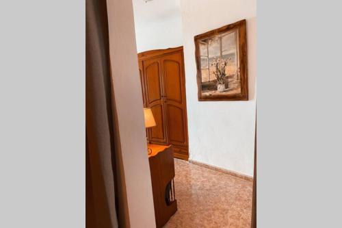 a room with a cabinet and a picture on the wall at LARGE 90m2 CANARY APARTMENT, NICE VIEW, LOCATION ! in Puerto de Santiago