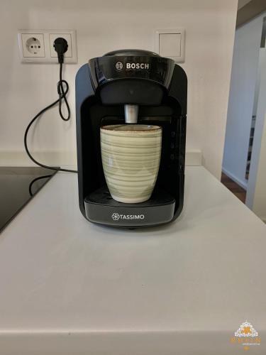 a coffee maker sitting on a counter with a bowl at Rhein Apartment Souterrain Study in Vallendar