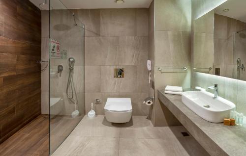 a bathroom with a toilet and a sink and a shower at Ephesia Holiday Beach Club in Kuşadası