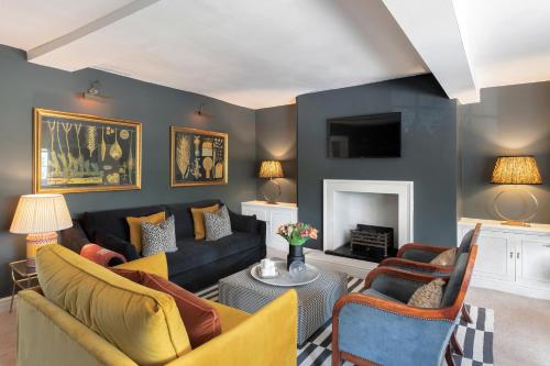 a living room with a couch and a fireplace at Central Apartment With Private Parking in Bath